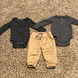 Two onesie long sleeve shirts and khaki pants